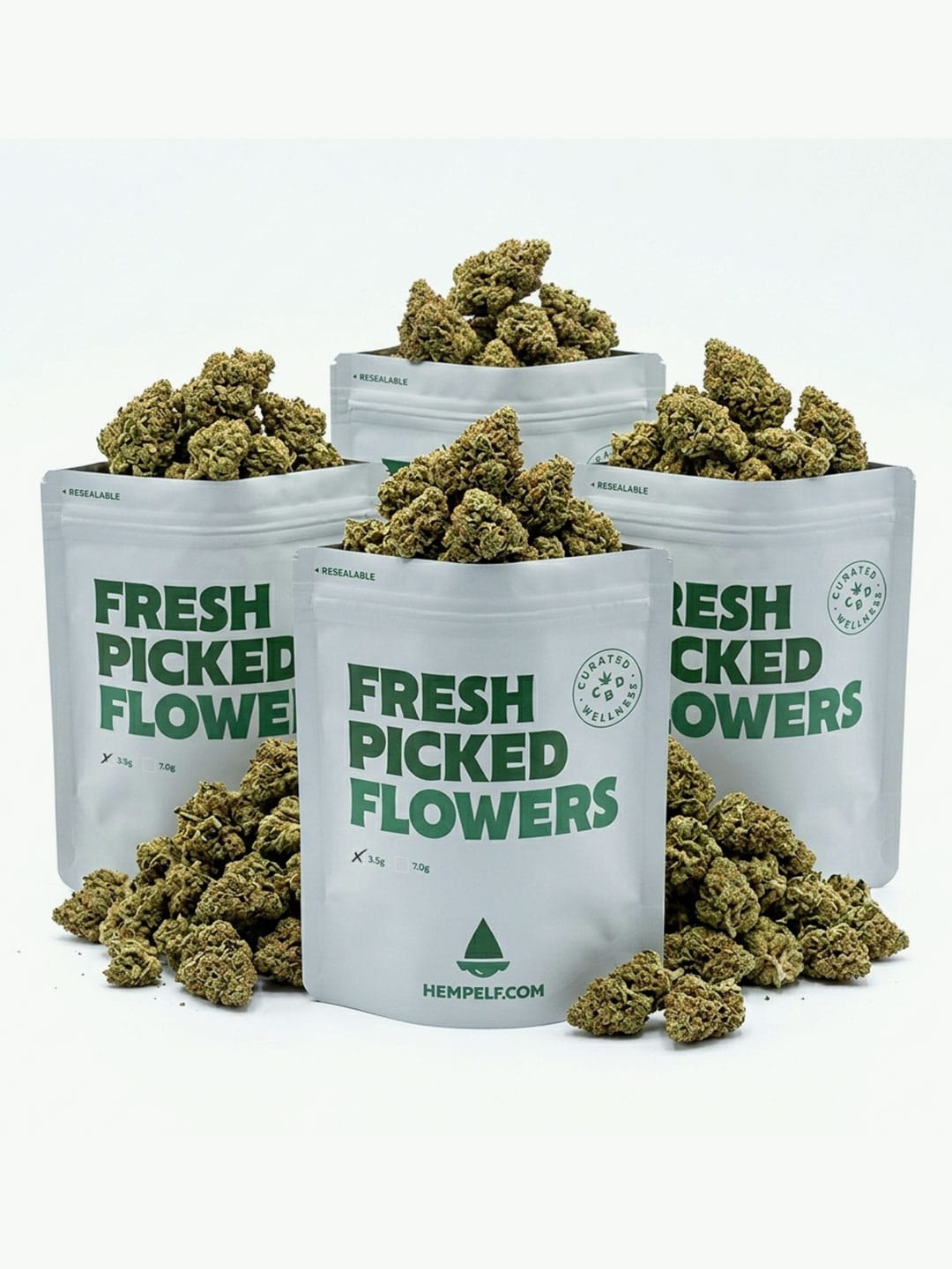 Four Greenhouse Bundle bags from HempElf.com, filled with green buds, are labeled and arranged together.