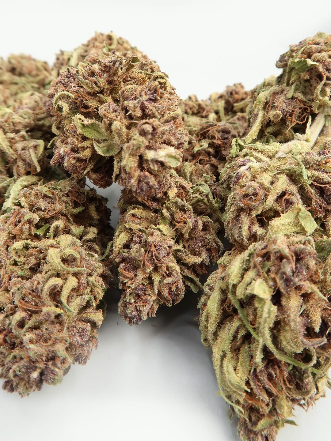 Close-up of Sour Diesel CBD Budget Hemp Flower (8-13% CBD) by HempElf, showing trichomes on a white background.
